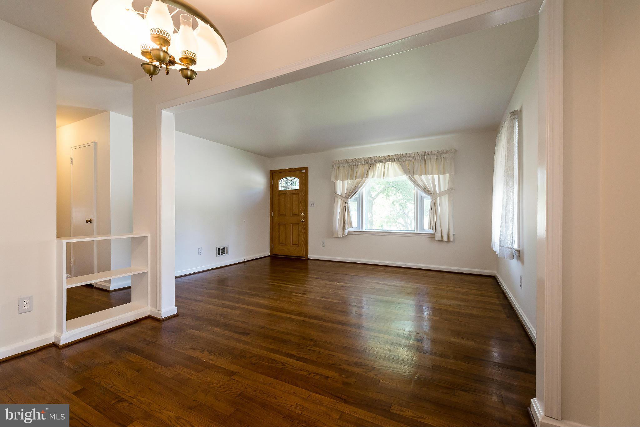 11809 Indigo Road Silver Spring, MD 20906 - Photo 9 of 30 an empty room with wooden floor fan and windows