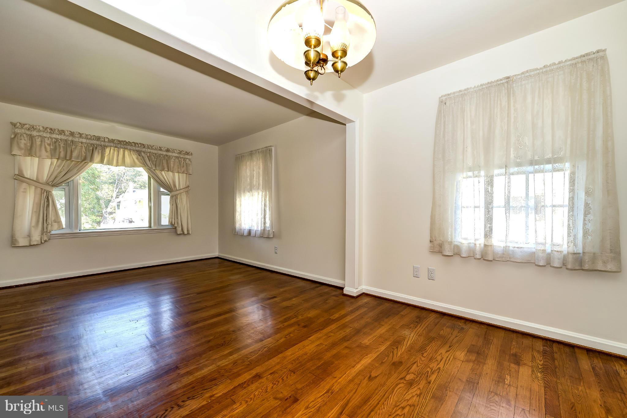 11809 Indigo Road Silver Spring, MD 20906 - Photo 10 of 30 an empty room with wooden floor and windows