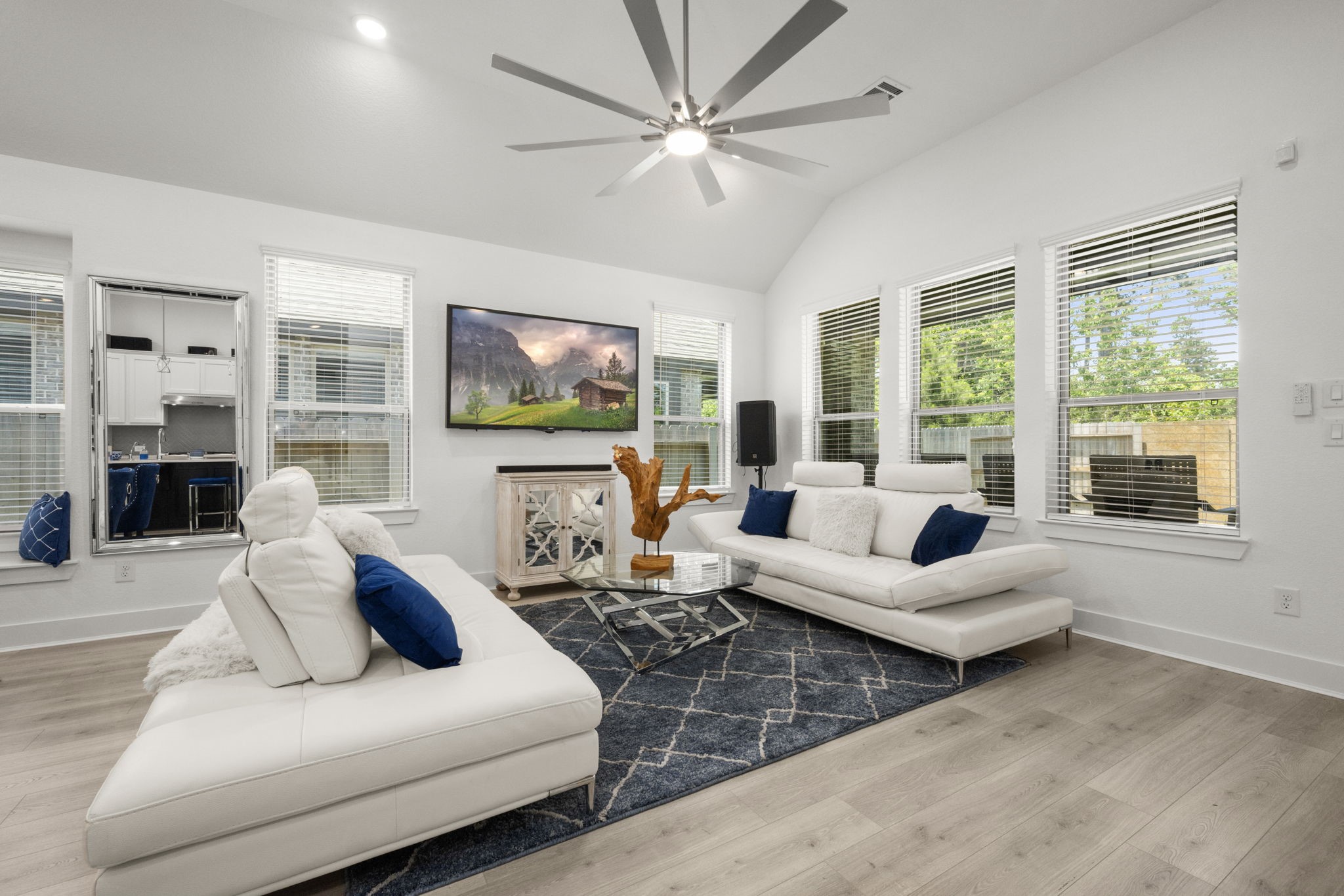 13035 Wandering Rdg Lane Conroe, TX 77302 - Photo 6 of 28 a living room with furniture flat screen tv and large windows