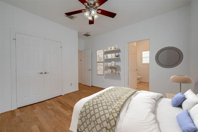 a bedroom with bed and a chandelier