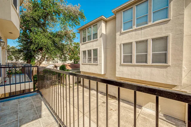 a view of a house with a small yard and wooden fence