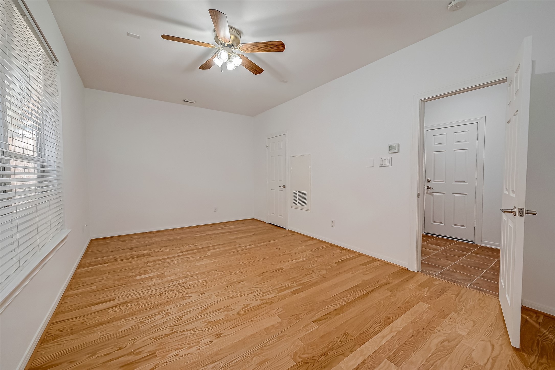 1507 Roy Street Houston, TX 77007 - Photo 4 of 20 a view of empty room with wooden floor and fan