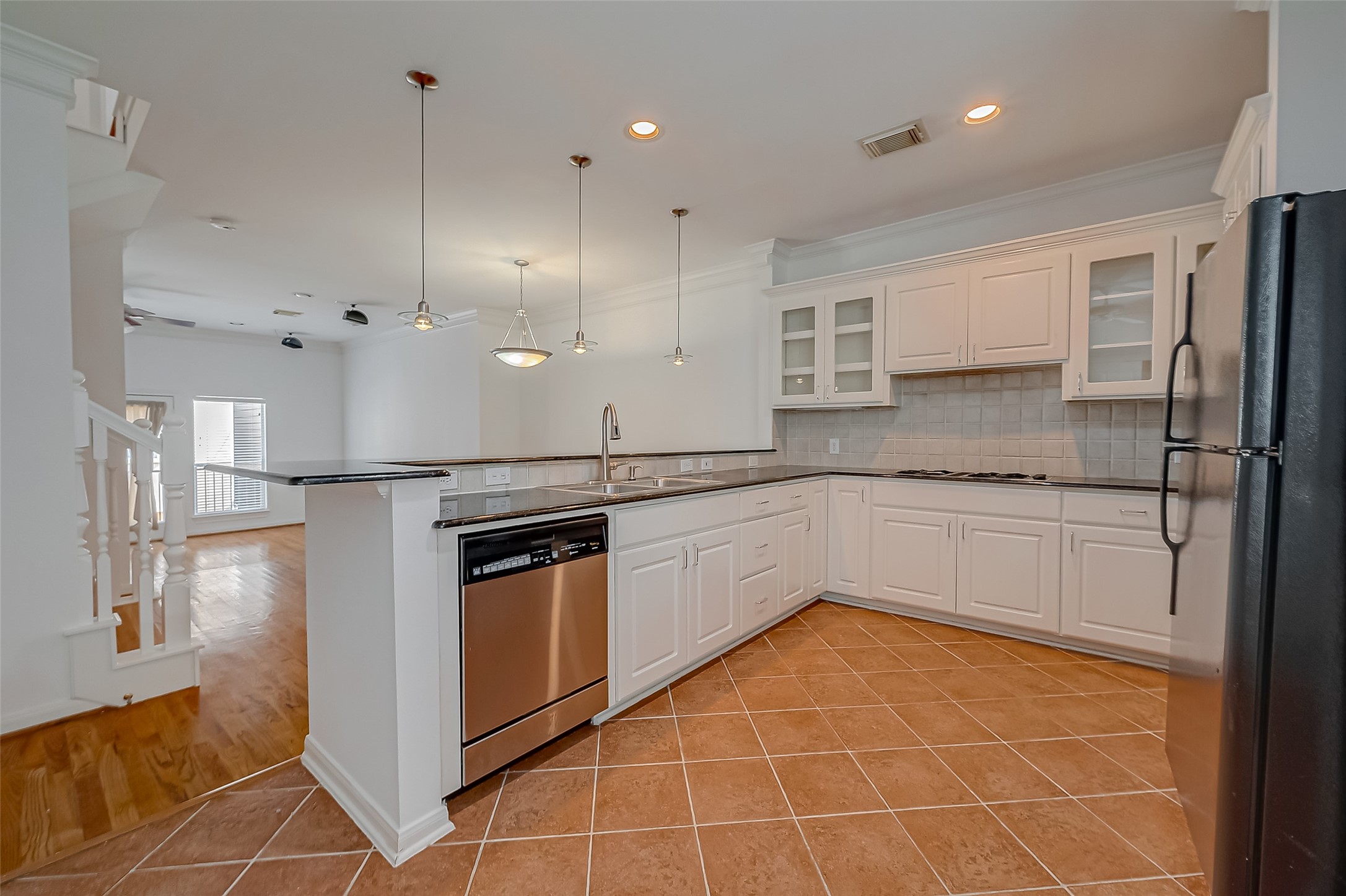 1507 Roy Street Houston, TX 77007 - Photo 10 of 20 a kitchen with stainless steel appliances granite countertop a sink a stove a refrigerator a center island and cabinets
