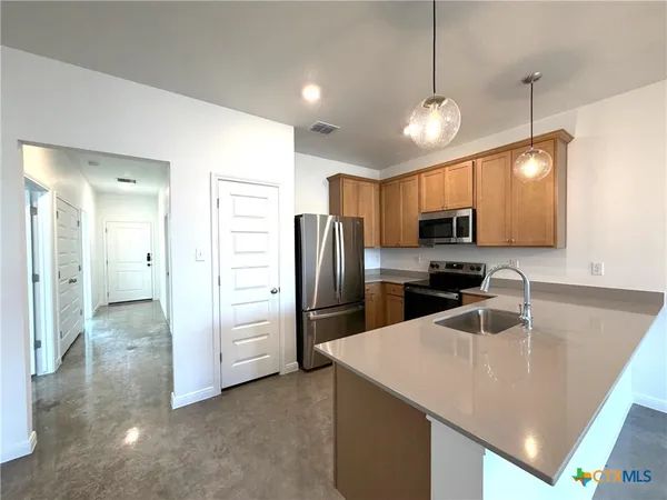 a kitchen with a refrigerator a sink and a stove