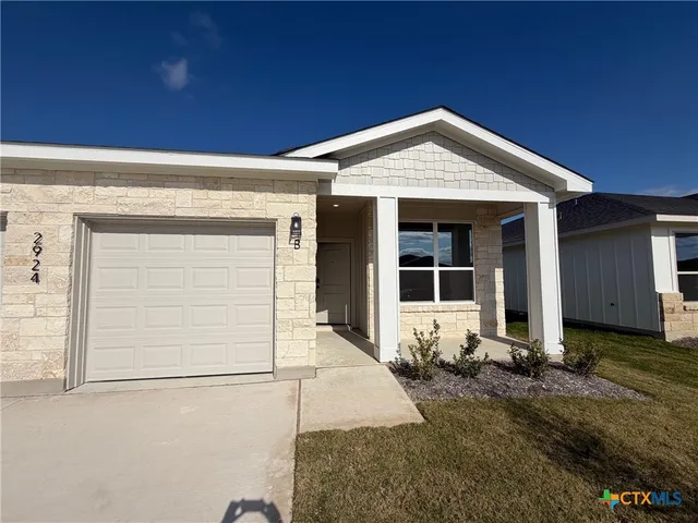 a front view of a house with yard