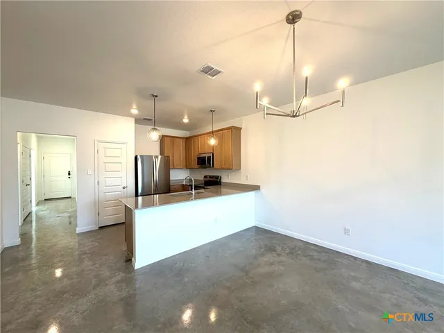a view of a living room and kitchen