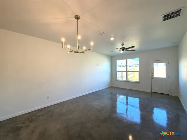 a view of empty room with a fireplace