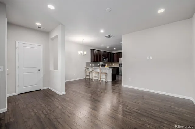 a view of kitchen with furniture and wooden floor