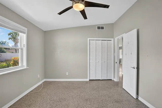 a view of room with air conditioner and windows