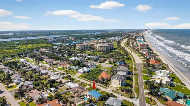 an aerial view of a house with a garden and swimming pool