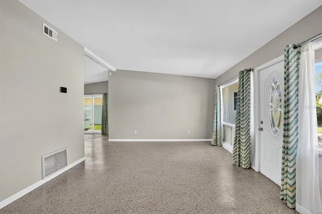 a living room with stainless steel appliances kitchen island granite countertop furniture and a kitchen view