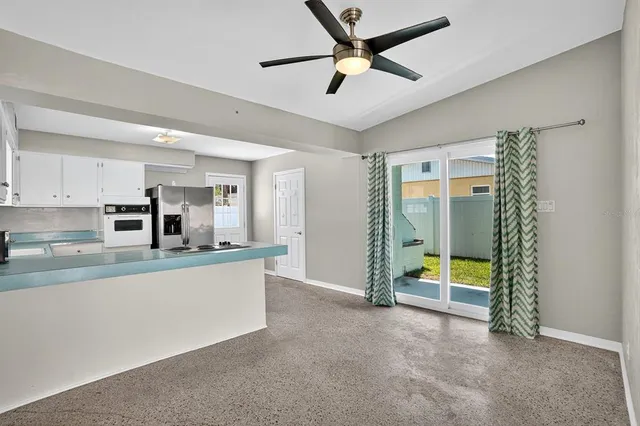 a view of a livingroom with a ceiling fan and window