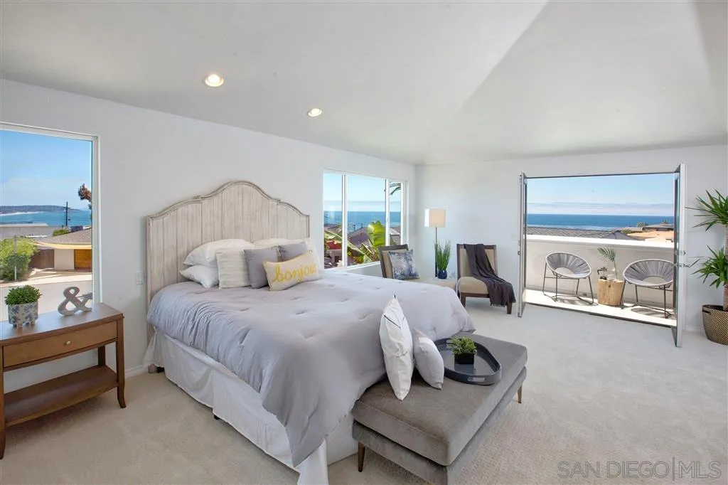 918 Sandpiper Place La Jolla, CA 92037 - Photo 13 of 25 a bedroom with a bed and a large window