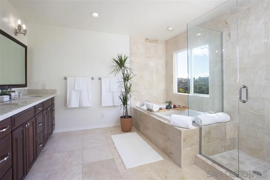 918 Sandpiper Place La Jolla, CA 92037 - Photo 14 of 25 a spacious bathroom with a tub sink and mirror