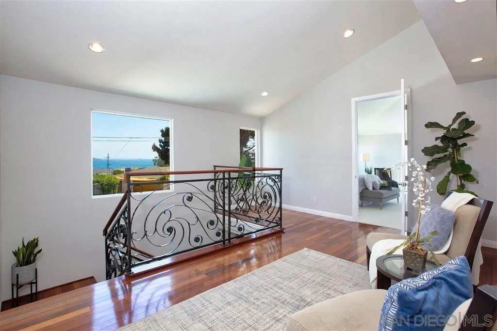 918 Sandpiper Place La Jolla, CA 92037 - Photo 15 of 25 a bedroom with furniture and a wooden floor
