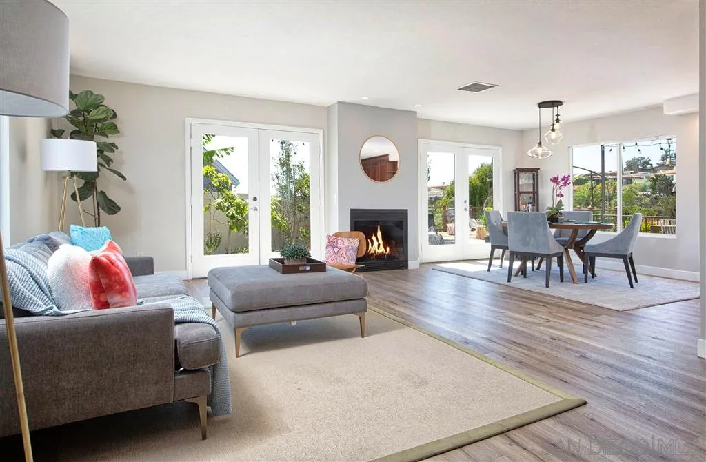 918 Sandpiper Place La Jolla, CA 92037 - Photo 4 of 25 a living room with furniture fireplace and a large window