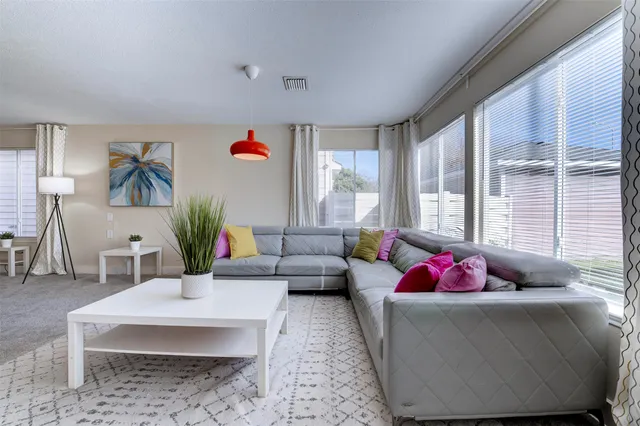 a living room with furniture and a large window