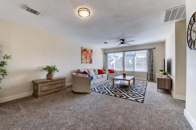 a living room with furniture and a large window