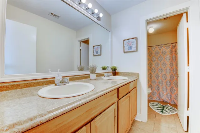 a white toilet sitting next to a shower curtain