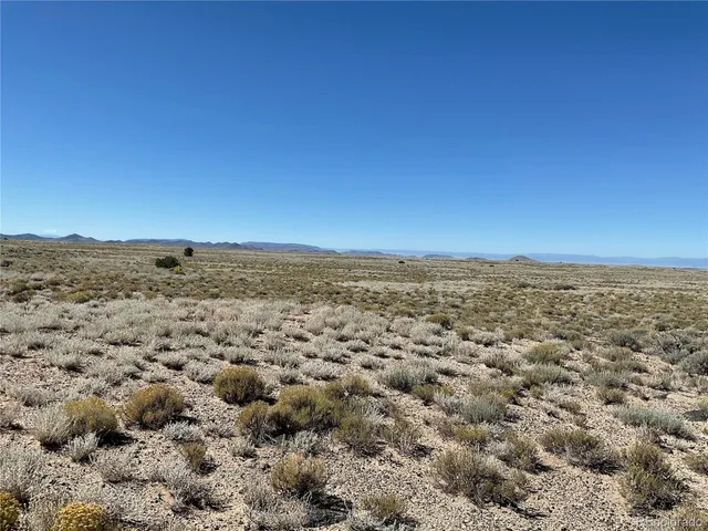 a view of an ocean beach and mountain