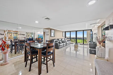 a view of a dining room and livingroom with lots of furniture and garden view