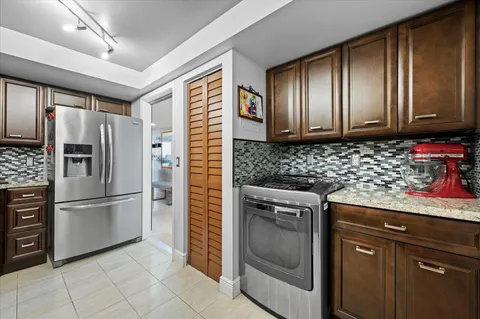 a kitchen with granite countertop stainless steel appliances and cabinets