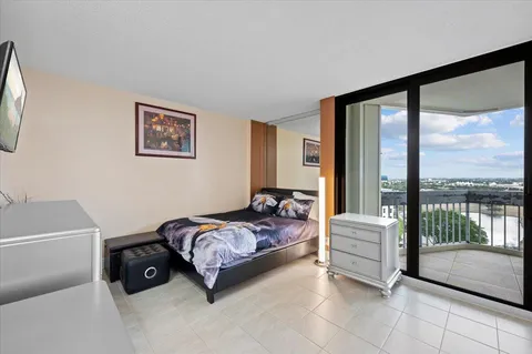 a bedroom with a bed and a large window