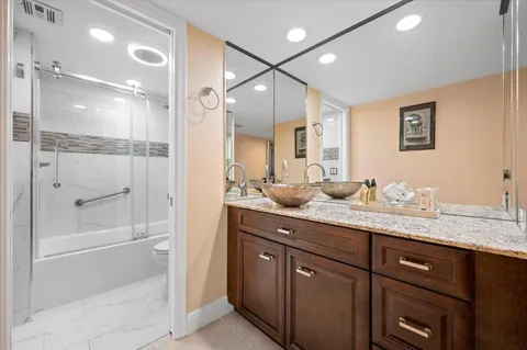a bathroom with a granite countertop sink mirror and double