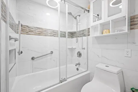 a bathroom with a toilet and a shower