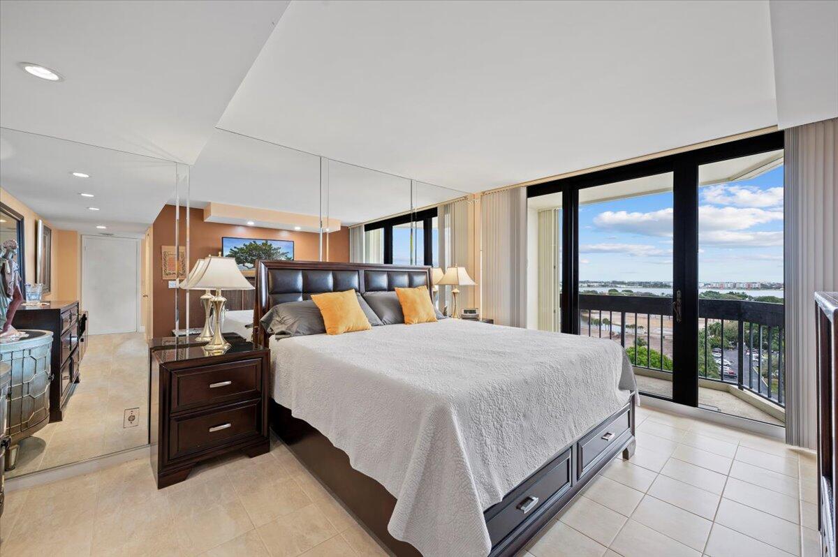 2400 Presidential Way, Unit 1204 West Palm Beach, FL 33401 - Photo 20 of 55 a bed room with a bed and a large window