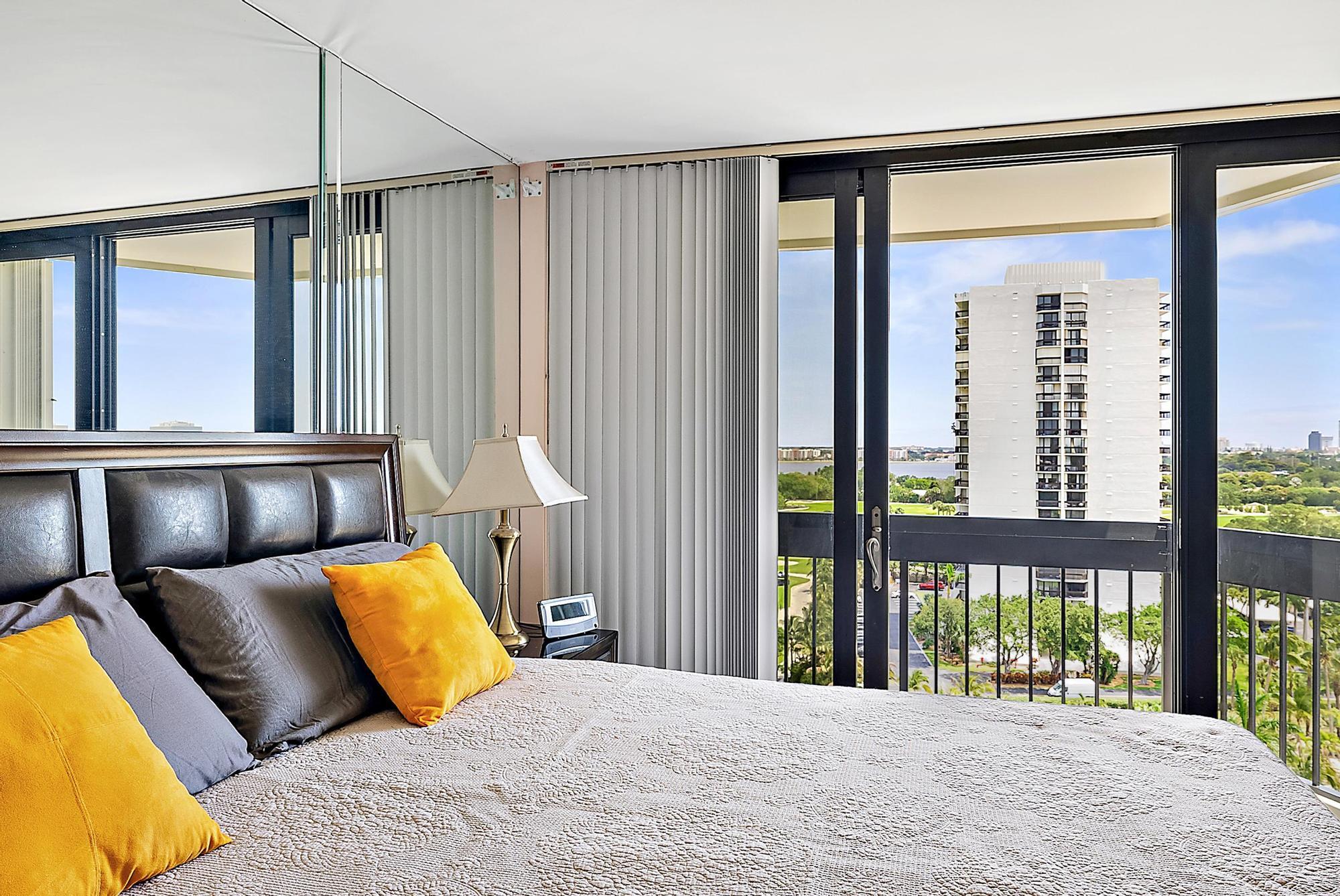 2400 Presidential Way, Unit 1204 West Palm Beach, FL 33401 - Photo 21 of 55 a bedroom with a large bed and a large window