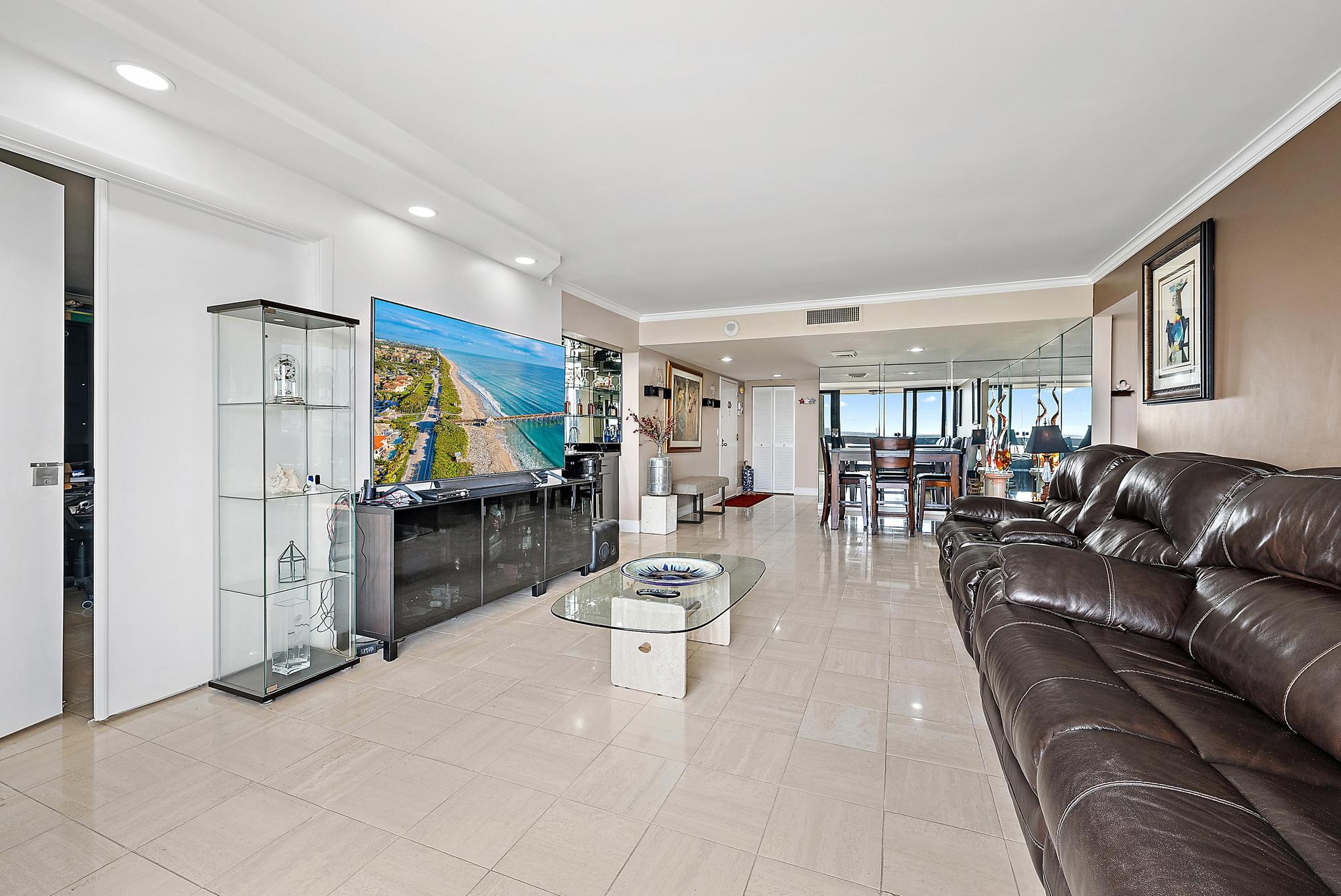 2400 Presidential Way, Unit 1204 West Palm Beach, FL 33401 - Photo 6 of 55 a living room with furniture and a flat screen tv