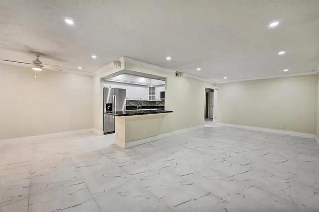 a view of kitchen with refrigerator and stove