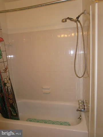 a bathroom with a shower and a shower