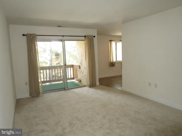 a view of an empty room with glass door