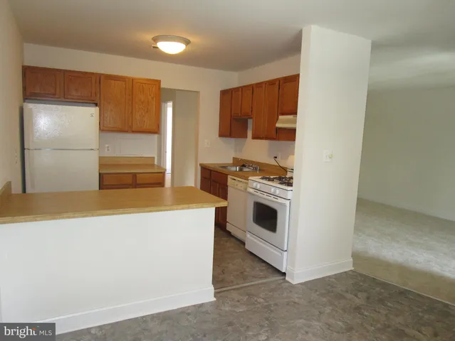 a kitchen with a stove and a refrigerator