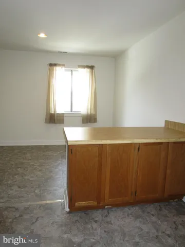 an empty room with wooden floor