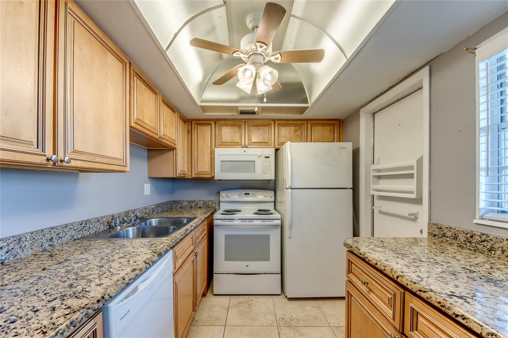 1003 Tropic Terrace North Fort Myers, FL 33903 - Photo 11 of 35 a kitchen with stainless steel appliances granite countertop a sink a stove and refrigerator