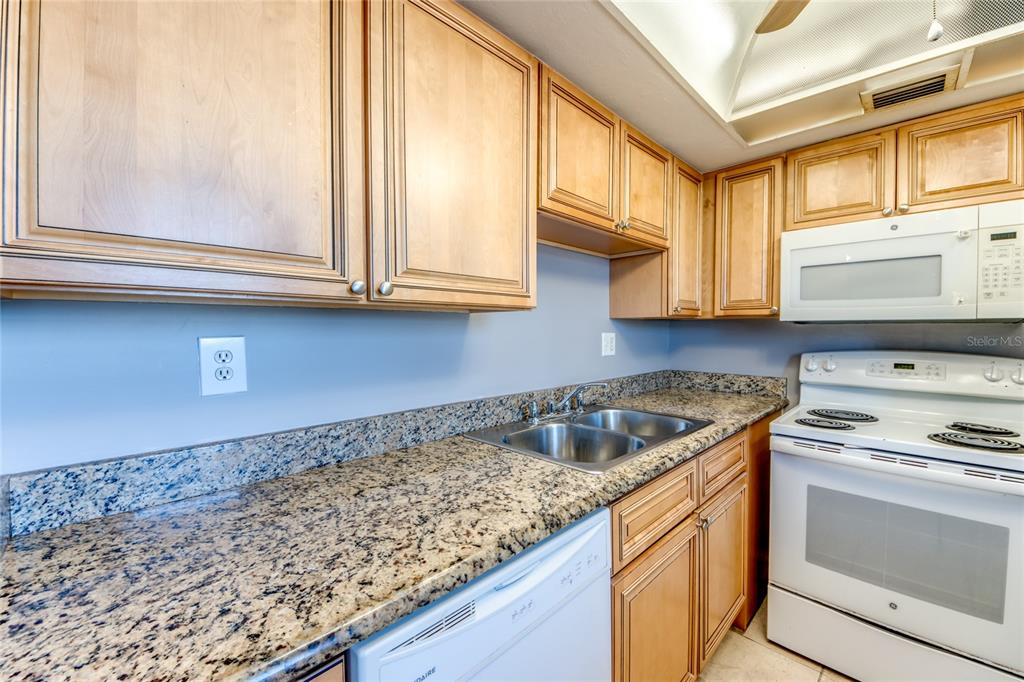 1003 Tropic Terrace North Fort Myers, FL 33903 - Photo 13 of 35 a kitchen with granite countertop a sink and cabinets