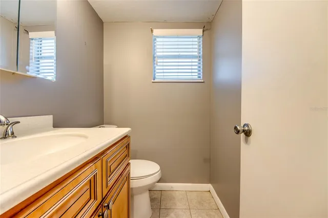 a bathroom with a sink a toilet and a window