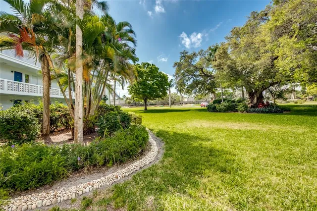 a view of yard with swimming pool and green space