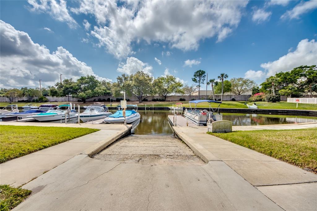 1003 Tropic Terrace North Fort Myers, FL 33903 - Photo 29 of 35 a view of swimming pool that has lawn chairs with plants and lake view