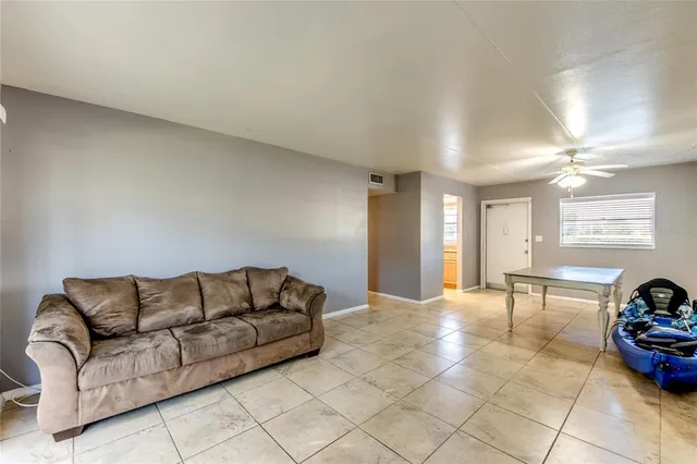 a living room with furniture a table and chairs