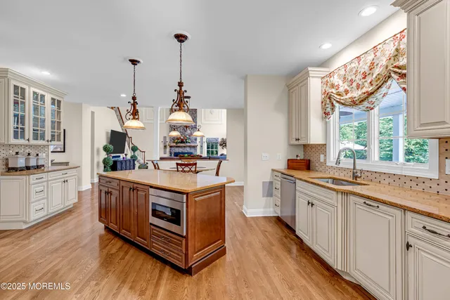 a view of a a dining room with furniture window and wooden floor