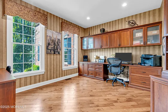 a spacious bathroom with a tub sink and glass door