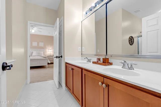 a view of a patio with a dining table and chairs under an umbrella with a barbeque grill and plants