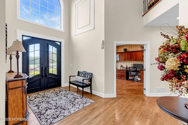 a view of entryway livingroom and hall with wooden floor