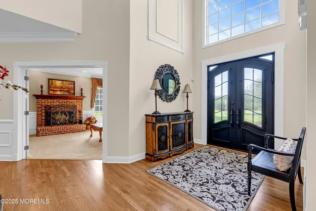 a view of a dining room and livingroom with furniture wooden floor a chandelier