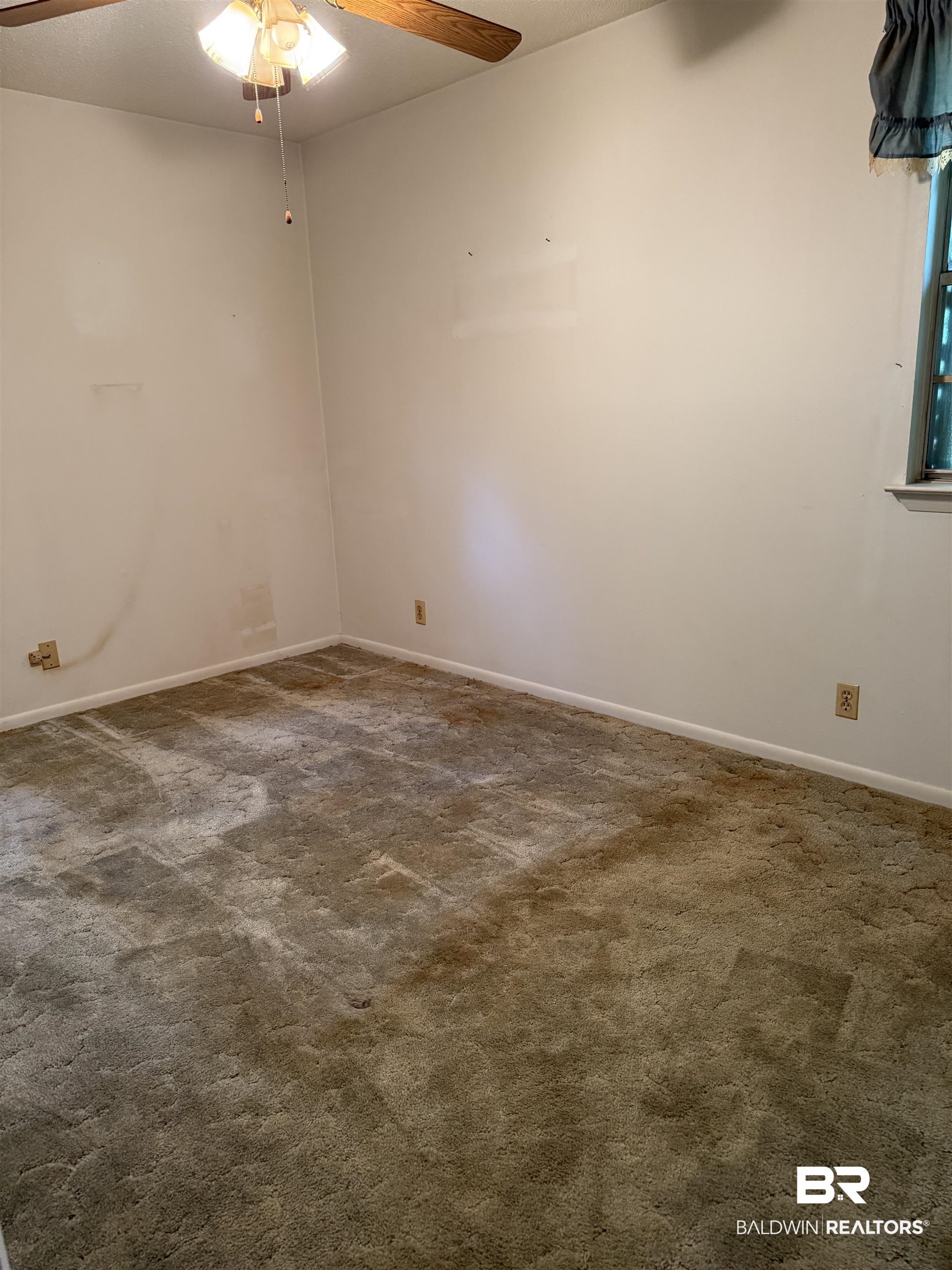 607 West Lee Street Mobile, AL 36611 - Photo 9 of 11 Spare room with ceiling fan and dark carpet
