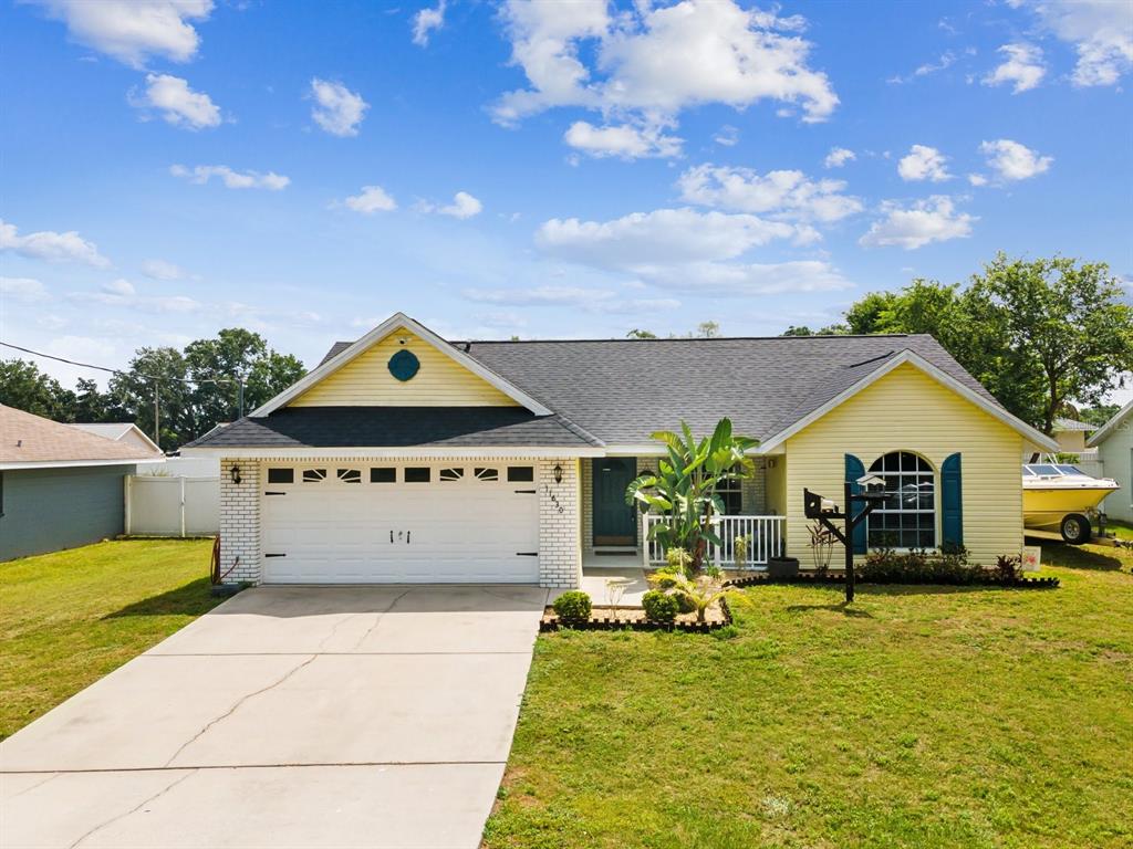 a view of swimming pool with lawn chairs and plants